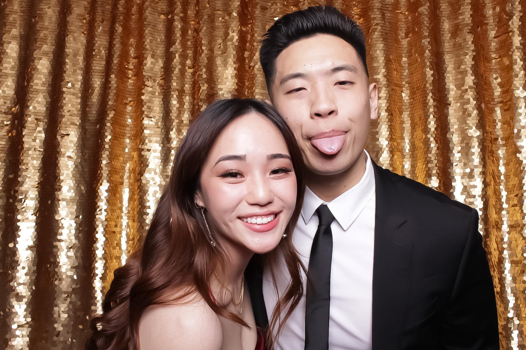 Couple at gold sequin Legacy Booth wedding